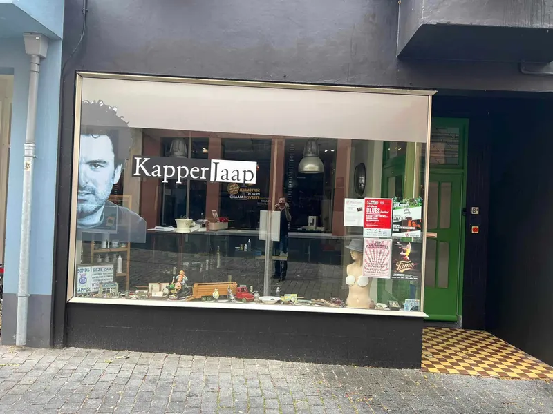Etalage met raamprint van groot portret en belettering met logo